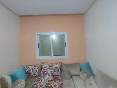 a living room with a couch and a window at Big family house sohofi in Casablanca