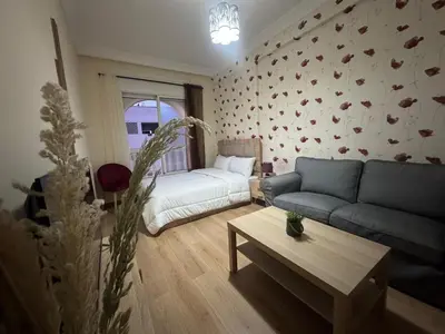 a living room with a couch and a table at super studio vue sur mer pour les familles in Rabat
