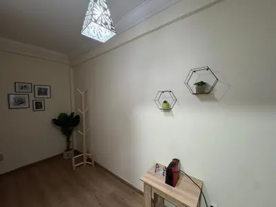 a room with a white wall with a table and a skylight at super studio vue sur mer pour les familles in Rabat