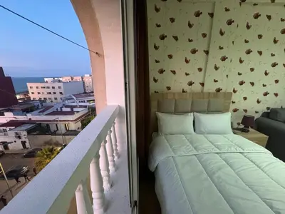 a bedroom with a bed on a balcony at super studio vue sur mer pour les familles in Rabat