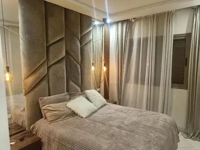 a bedroom with a bed and a stone wall at Appartement a belvédère in Casablanca