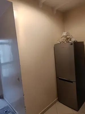 a small kitchen with a refrigerator in a room at Appartement a belvédère in Casablanca