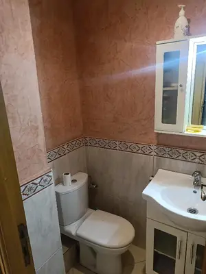 a bathroom with a toilet and a sink at Appartement a belvédère in Casablanca