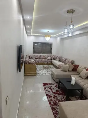 a living room with a couch and a tv at Appartement a belvédère in Casablanca