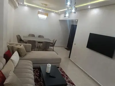 a living room with a couch and a table at Appartement a belvédère in Casablanca