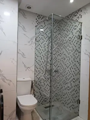 a bathroom with a toilet and a glass shower at Bati d or in Mohammedia