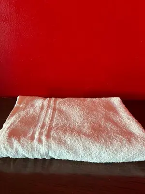 a white towel sitting next to a red wall at Casablanca Family in Casablanca