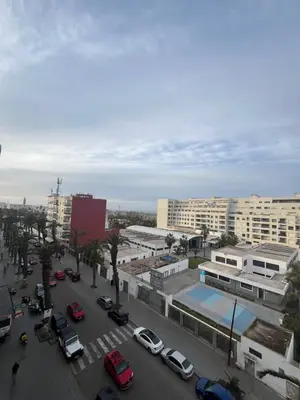 a city with cars parked in a parking lot at Casablanca Family in Casablanca