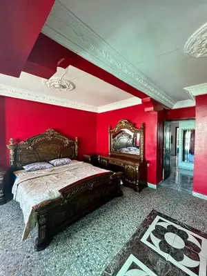 a bedroom with red walls and a large bed at Casablanca Family in Casablanca
