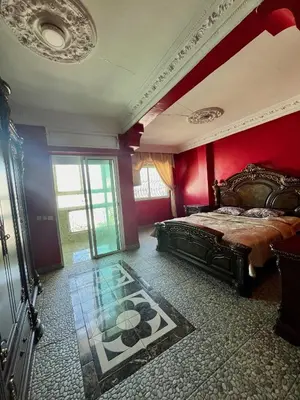 a bedroom with a bed and a red wall at Casablanca Family in Casablanca