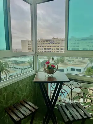 a table with a basket of flowers on a balcony at Casablanca Family in Casablanca