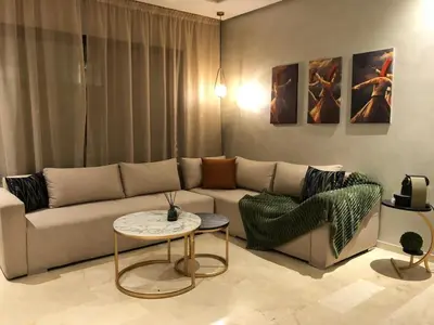 a living room with a couch and a table at Cosy C35 in Casablanca