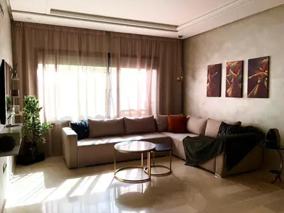 a living room with a couch and a table at Cosy C35 in Casablanca