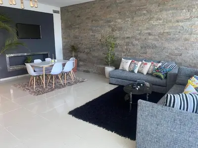 a living room with a couch and a table at Melrose beach apartment in Tamaris