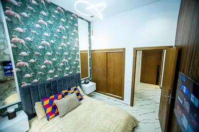 a bedroom with a wall with a mural of flamingos at casablanca maroc in Casablanca