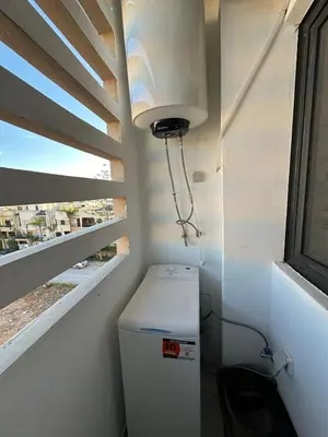 a small bathroom with a toilet and a window at Bel Appartement à Harhoura pour les familles in El Harhoura
