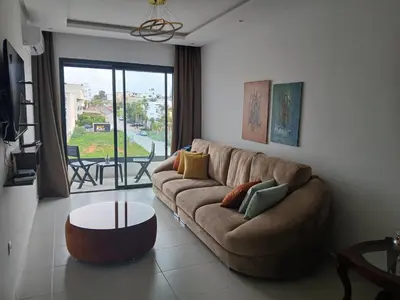 a living room with a couch and a table at Bel Appartement à Harhoura pour les familles in El Harhoura