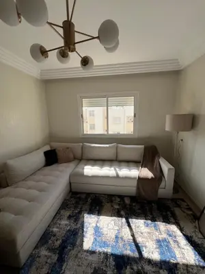 a living room with a white couch and a window at L'Appart du Carousel in Rabat