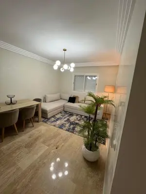 a living room with a couch and a table at L'Appart du Carousel in Rabat