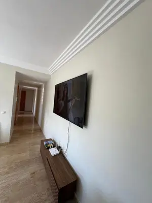 a living room with a flat screen tv on a wall at L'Appart du Carousel in Rabat