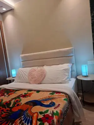 a bedroom with a bed with a headboard and pillows at Luxury studio 20 in Casablanca