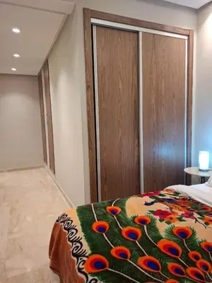 a bedroom with a bed with a colorful blanket at Luxury studio 20 in Casablanca