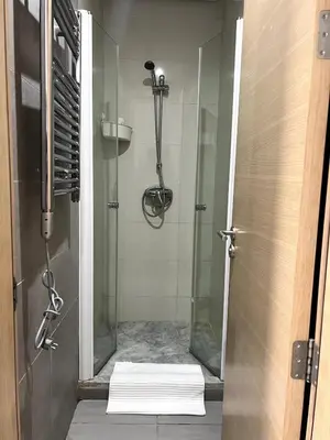 a bathroom with a shower with a glass door at 1 bed apt In Prestigia hay Riad rabat in Rabat