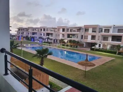 a view of an apartment complex with a swimming pool at Appartement ALAA - Malaga beach in Mansouria
