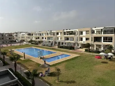 a large apartment complex with a swimming pool in a yard at Appartement ALAA - Malaga beach in Mansouria