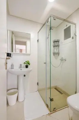 a bathroom with a glass shower and a sink at Rabat Centro Apartments in Rabat