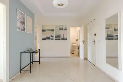 a hallway with white walls and a glass table at Rabat Centro Apartments in Rabat