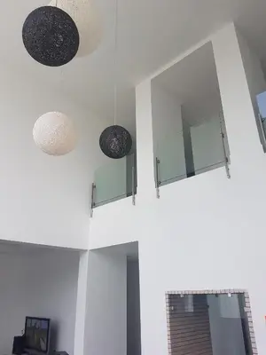 two lights and mirrors on the wall of a room at Eden Island Villa - Bouznika in Bouznika