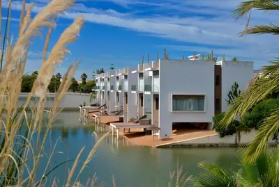 a building sitting on top of a body of water at Eden Island Villa - Bouznika in Bouznika