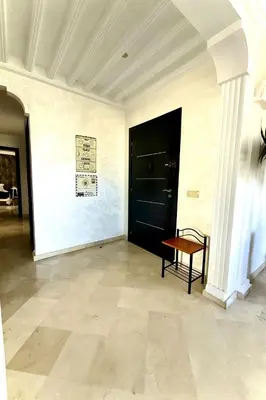 a room with a black door and a bench in it at Oumadane Appart-Ocean view- Amazing apartment-International Fair and more near by in Casablanca