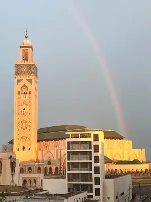 a large building with a clock tower in front of it at Oumadane Appart-Ocean view- Amazing apartment-International Fair and more near by in Casablanca