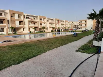 a swimming pool in the middle of a building at Appartement Alaa in Mansouria