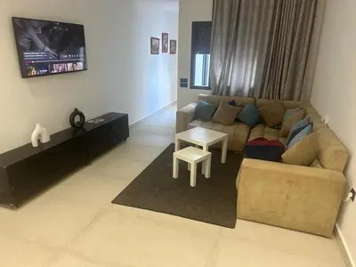 a living room with a couch and a table at زنقة توبقال أكدال عمارة 24 رقم 3 in Rabat