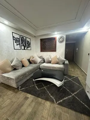 a living room with a couch and a rug at شقة فأكدال in Rabat