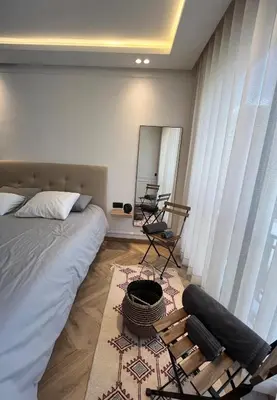 a bedroom with a bed and a desk and a mirror at Cocon au coeur de Casablanca in Casablanca