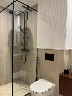 a bathroom with a toilet and a glass shower at Cocon au coeur de Casablanca in Casablanca