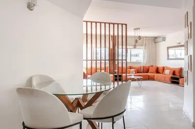 a dining room with a glass table and chairs at Spacious 2Bedrooms Fully equipped-5min Agdal Station in Rabat