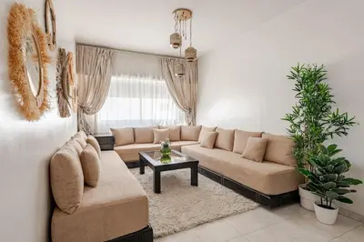 a living room with a couch and a table at Spacious 2Bedrooms Fully equipped-5min Agdal Station in Rabat