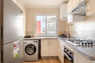 a kitchen with a washing machine and a window at Modern 1 Bedroom W Terrace- Rabat City Center in Rabat