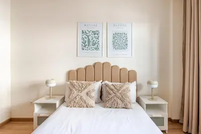 a bedroom with a white bed with two night stands at Modern 1 Bedroom W Terrace- Rabat City Center in Rabat