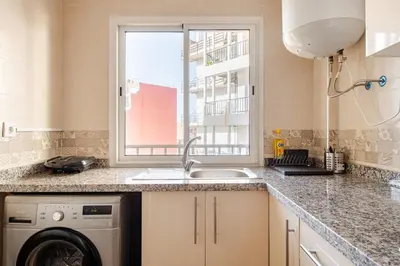a kitchen with a sink and a washing machine at Modern 1 Bedroom W Terrace- Rabat City Center in Rabat