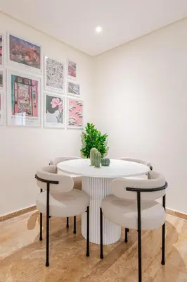 a dining room with a white table and chairs at Modern 1 Bedroom W Terrace- Rabat City Center in Rabat
