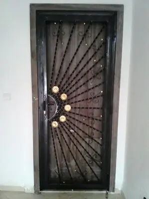a wooden door with a metal design on it at résidence les perles de Bouznika in Bouznika