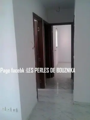 an empty room with a door and a hallway at résidence les perles de Bouznika in Bouznika