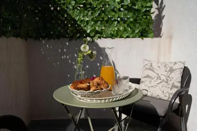 a table with a bowl of food and a glass of orange juice at Studio Cosy, corniche à 2 min , Parking , Netflix in Casablanca