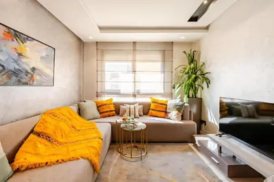 a living room with a couch and a table at Studio Cosy, corniche à 2 min , Parking , Netflix in Casablanca